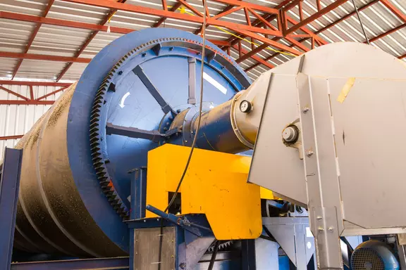 Large industrial rotary drum equipment in a processing facility.