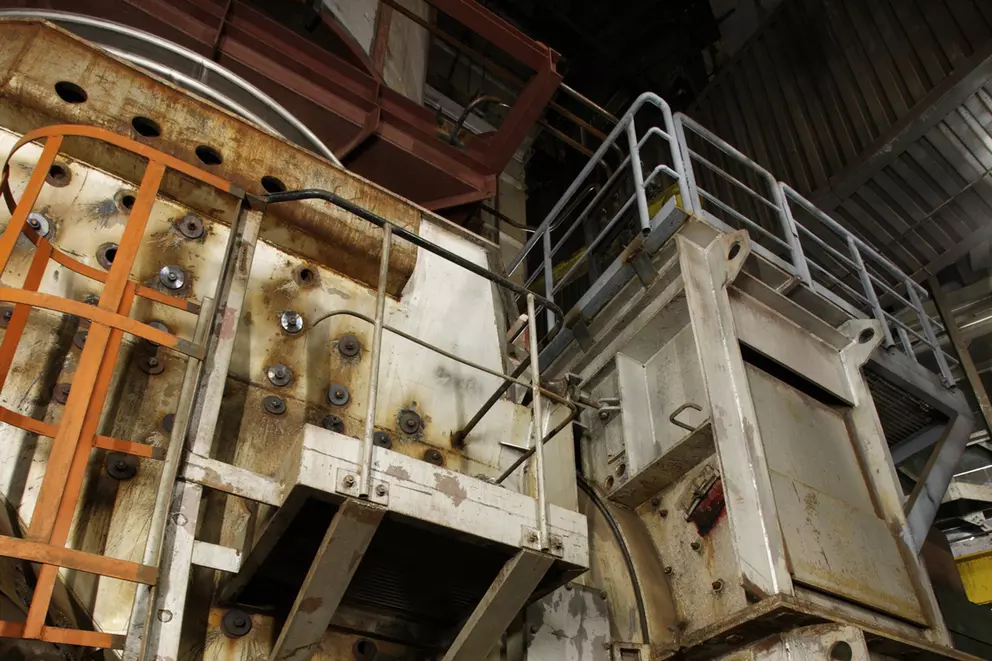 Industrial processing equipment with access platforms inside a plant facility.