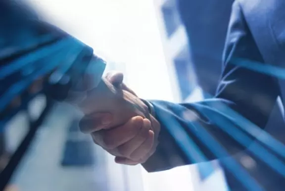 Close-up of a handshake between two business professionals, symbolizing partnership, trust, and successful collaboration.