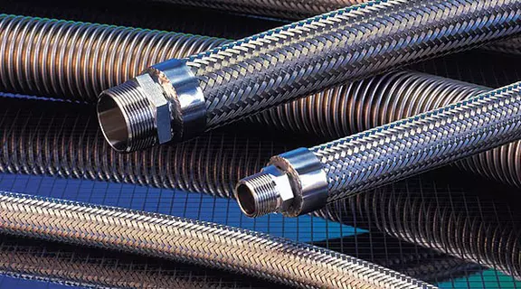 Braided and corrugated metal hoses with threaded fittings for durable industrial fluid transfer applications.