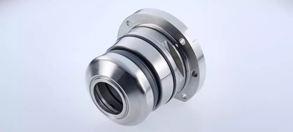 A clean, close-up studio shot of a shiny, stainless steel industrial mechanical seal or pump component with a flared end and a mounting flange.
