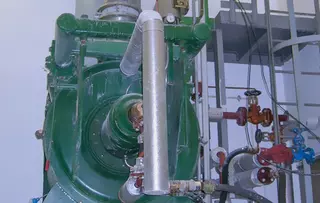 Industrial system with large vessel, valves, and connected piping.