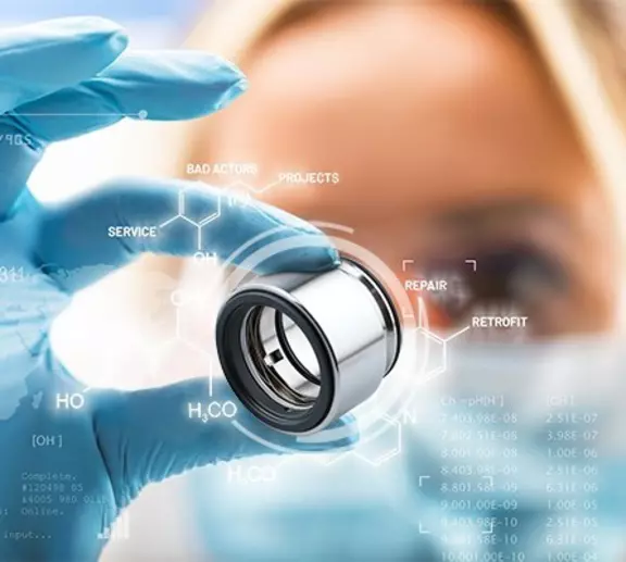 Technician holding an industrial mechanical seal with digital service, repair and retrofit information.