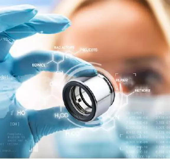 Gloved technician holding a mechanical seal component for industrial applications.
