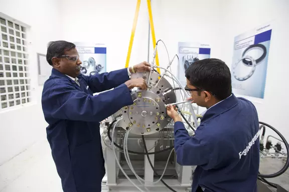 Two professionals inspect an EagleBurgmann industrial sealing system during a hands-on technical workshop.