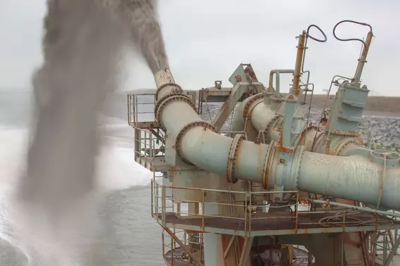 Pipeline system of a suction dredger discharging sediment and water.