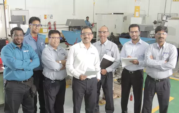 EagleBurgmann team standing in a production facility, highlighting technical expertise and industrial workforce collaboration.
