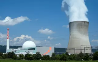 Nuclear power plant with cooling tower and reactor buildings, representing EagleBurgmann DF-SA with DiamondFace mechanical seal technology in demanding power generation applications.