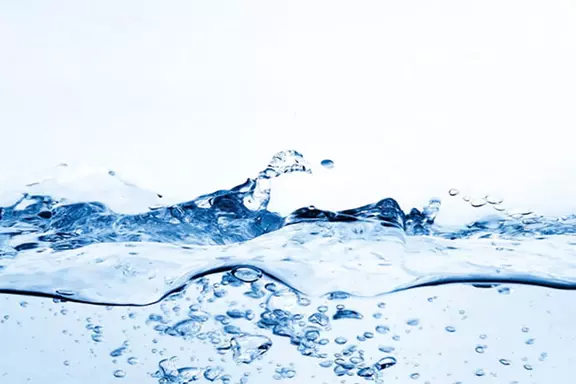 Clear water surface with bubbles and splash detail, representing water-related industrial applications and fluid handling solutions.