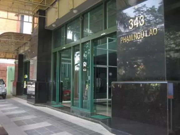 EagleBurgmann office entrance at 343 Pham Ngu Lao with glass doors and a polished black stone facade in an urban business setting.