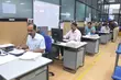 Office staff working at computer stations in an industrial business environment, highlighting administrative operations, engineering support, and team coordination within a technical company.