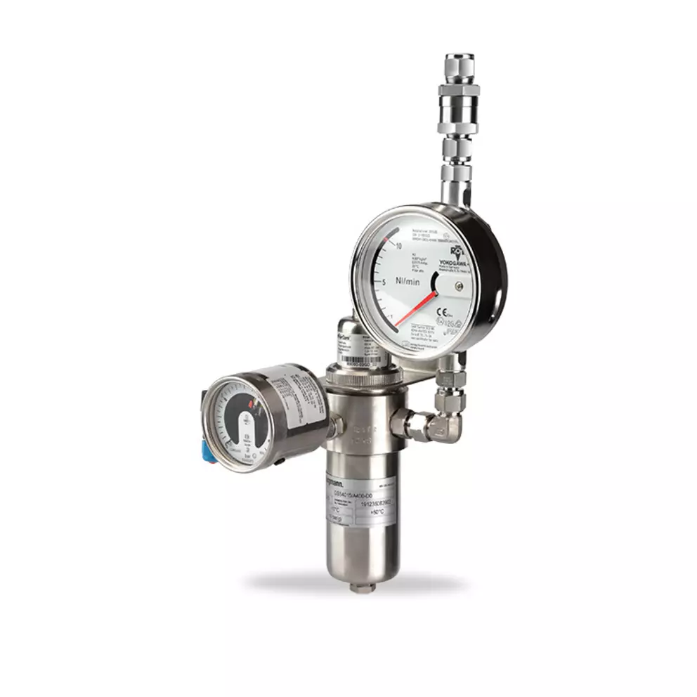 Compact EagleBurgmann stainless steel measuring and control unit with pressure and flow indicators, fittings, and instrumentation, shown on a light background for industrial sealing and process applications.