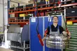 EagleBurgmann technician handling a large industrial mechanical seal component with lifting equipment in a workshop, highlighting heavy-duty service, precision handling, and technical expertise.