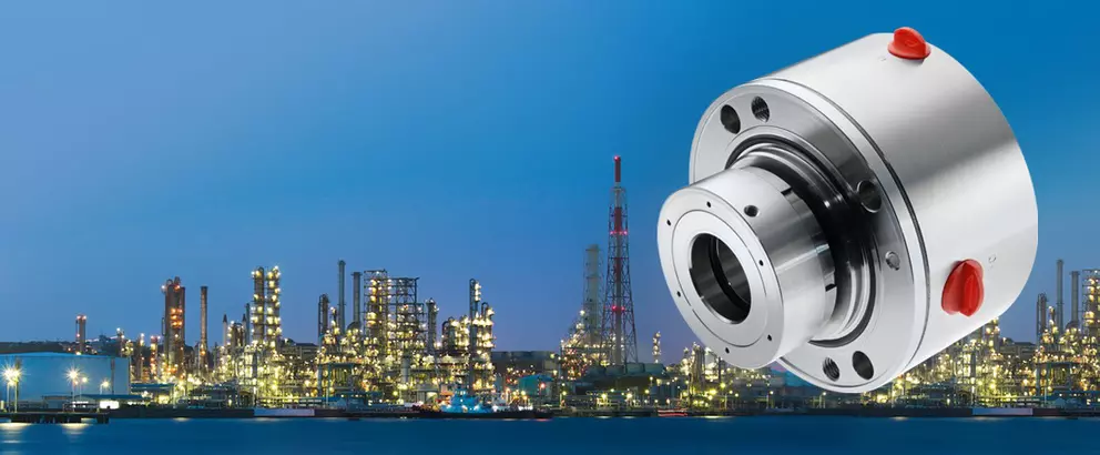 Industrial mechanical seal for refinery and petrochemical applications shown against an illuminated plant skyline, highlighting reliable sealing in demanding process environments.