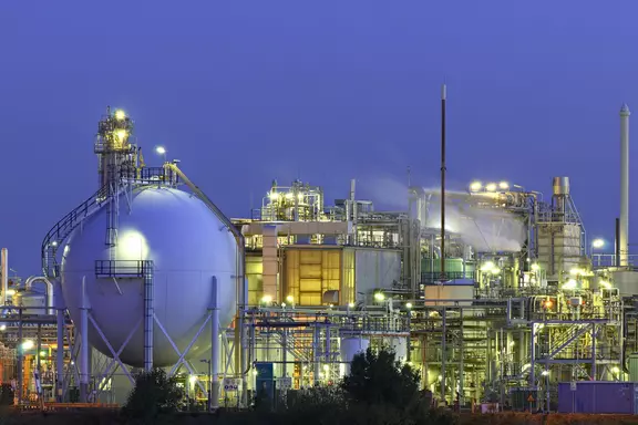 Chemical processing plant at night with illuminated storage tanks and industrial equipment, representing demanding applications in the chemical industry.