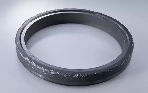 Corroded mechanical seal ring in close-up, showing surface degradation caused by harsh operating conditions in industrial sealing applications.