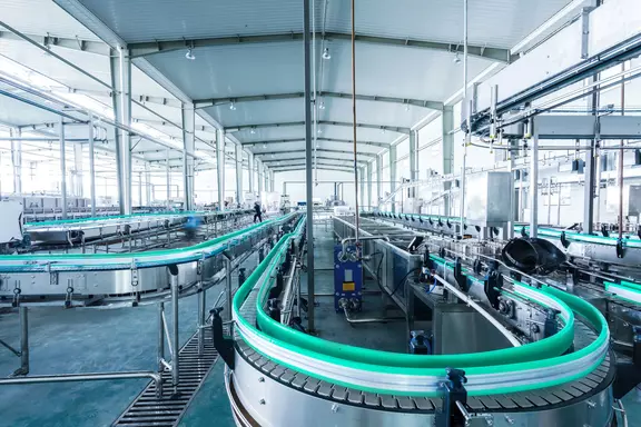 Conveyor system in a modern production hall with automated transport lines.
