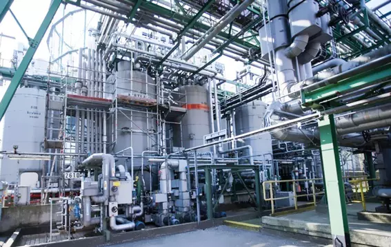 Industrial plant with vessels, piping, and process systems.