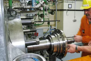 Technician installing a mechanical seal on industrial rotating equipment in a power plant, illustrating on-site maintenance and service for critical machinery.