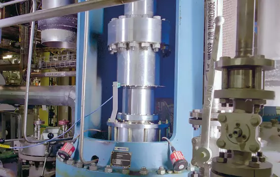 Industrial process system with vertical shaft, piping, and technical components.