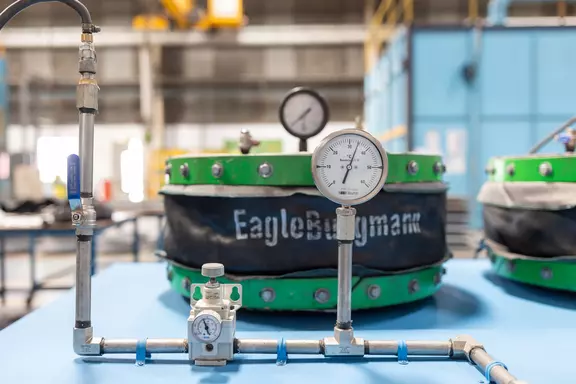 Industrial expansion joint test setup with pressure gauges and monitoring equipment for quality assurance and performance validation.