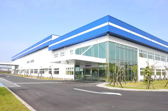 位於台灣的 EagleBurgmann 工業設施，具備現代藍白色建築外觀、玻璃入口與景觀綠化環境。