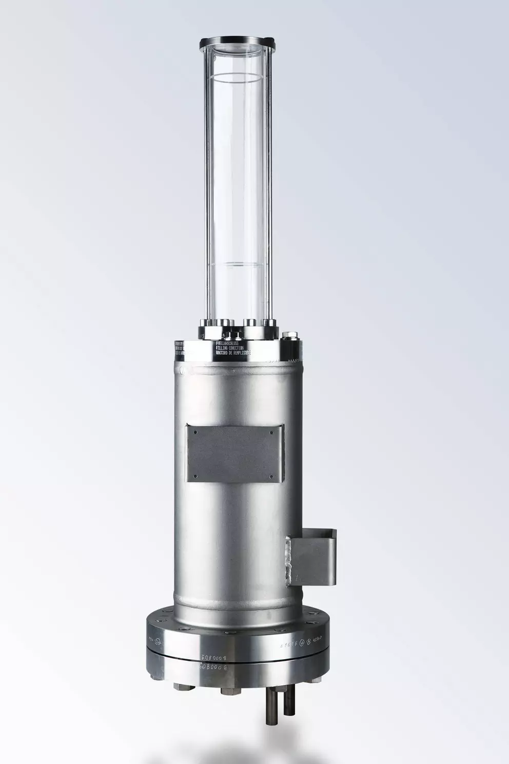 Shiny metallic industrial fluid reservoir or sight glass unit with a tall, clear glass column, mounted on a bolted flange.