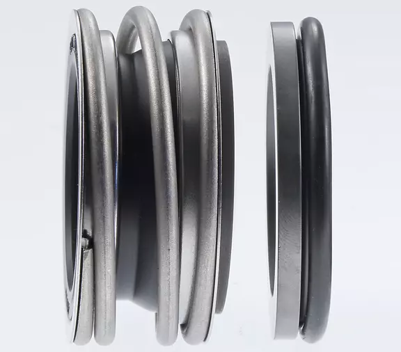 Mechanical seal with spring-loaded seal face and mating ring component, shown on a light background as a precision part for industrial sealing applications.
