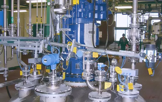 Industrial process system with agitator drive, piping, and instrumentation.