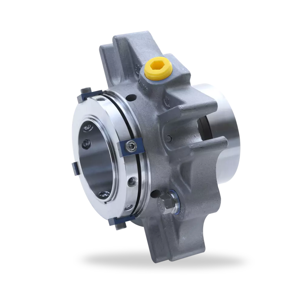 A detailed studio shot of a complex industrial mechanical seal assembly, featuring a gray cast housing with cooling fins, a silver sealing face, and a yellow cap on a fitting.